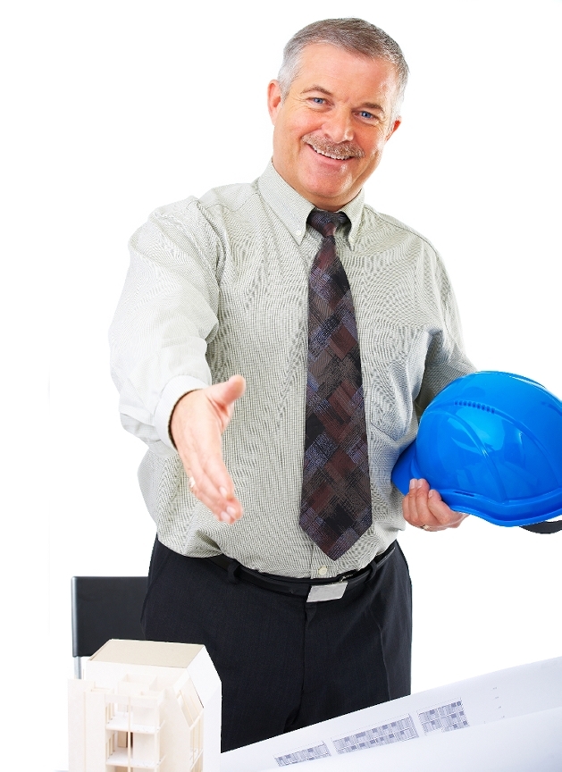 A hotel engineer smiling and extending a hand while holding a blue hard hat. - International Hotel School