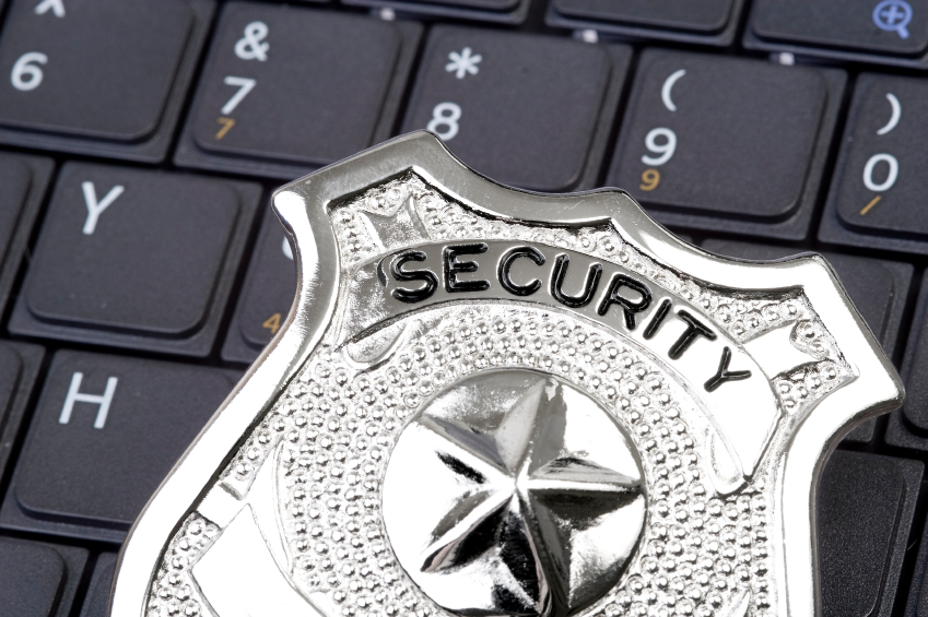 A silver security badge with the word 'SECURITY' displayed on a black keyboard. - International Hotel School