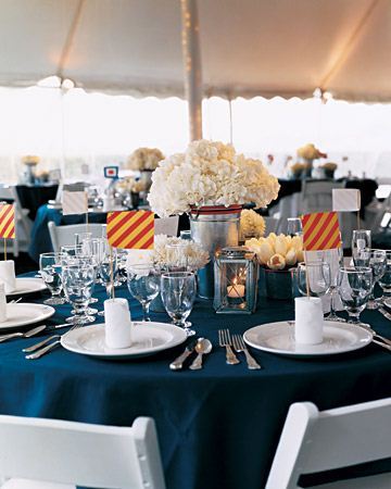 A beautifully arranged table setting featuring white flowers, glassware, and decorative elements. - International Hotel School