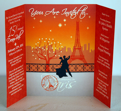 A dance invitation card featuring a silhouette couple dancing in front of the Eiffel Tower against an orange sunset. - International Hotel School