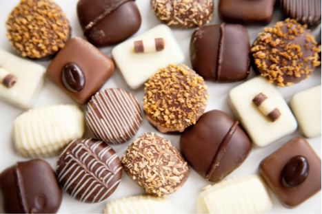 An assortment of various chocolate confections including dark, milk, and white chocolate pieces. - International Hotel School