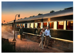 Couple standing near the Rovos Rail train platform during sunset with a porter in the background. - International Hotel School