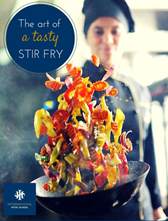 A chef skillfully tossing colorful vegetables in a wok while preparing a stir fry dish. - International Hotel School