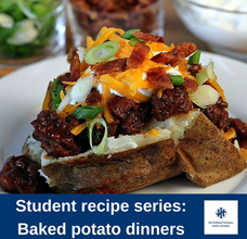 Baked potato topped with cheese, bacon, and green onions on a white plate. - International Hotel School