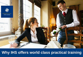 A waiter serving a drink to a woman seated at a dining table in a restaurant setting. - International Hotel School