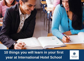Two students studying together in a classroom at International Hotel School, focusing on their textbooks. - International Hotel School