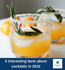 A cocktail garnished with rosemary and served in a glass with ice and a salted rim. - International Hotel School