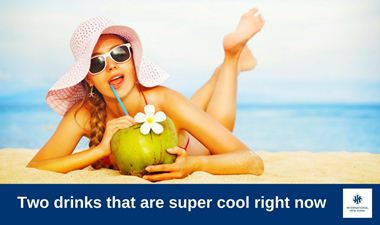 Woman in a sun hat and sunglasses enjoying a coconut drink on the beach. - International Hotel School