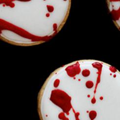 Cookies topped with white icing and red drizzles, resembling a blood-like pattern. - International Hotel School