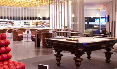 Interior view of a lounge area featuring a pool table and seating arrangements. - International Hotel School