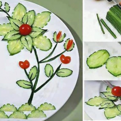 Artistic vegetable garnish arranged on a plate, featuring cucumbers and tomatoes shaped like flowers. - International Hotel School