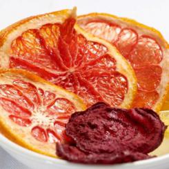 A bowl containing dried orange and beetroot slices arranged neatly for display. - International Hotel School