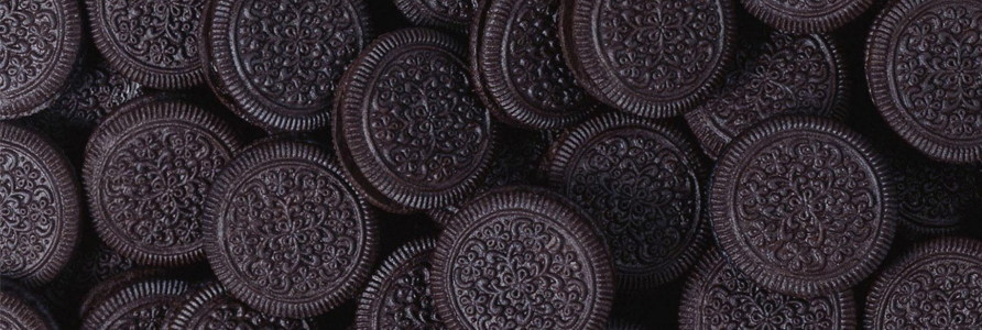 A collection of Oreo cookies arranged closely together, showcasing their distinct design. - International Hotel School