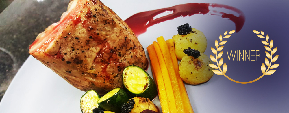 A gourmet dish featuring a piece of meat, vegetables, and a decorative sauce on a plate. - International Hotel School