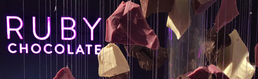 Various pieces of ruby chocolate displayed with a purple background and the text 'RUBY CHOCOLATE'. - International Hotel School