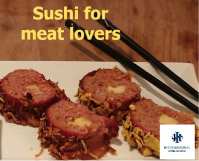A plate of sushi rolls made with meat, featuring a crispy exterior and chopsticks beside it. - International Hotel School