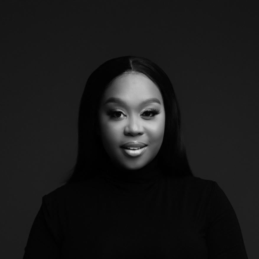 Black and white portrait of Mandy Mavuso with a neutral expression and long hair. - International Hotel School